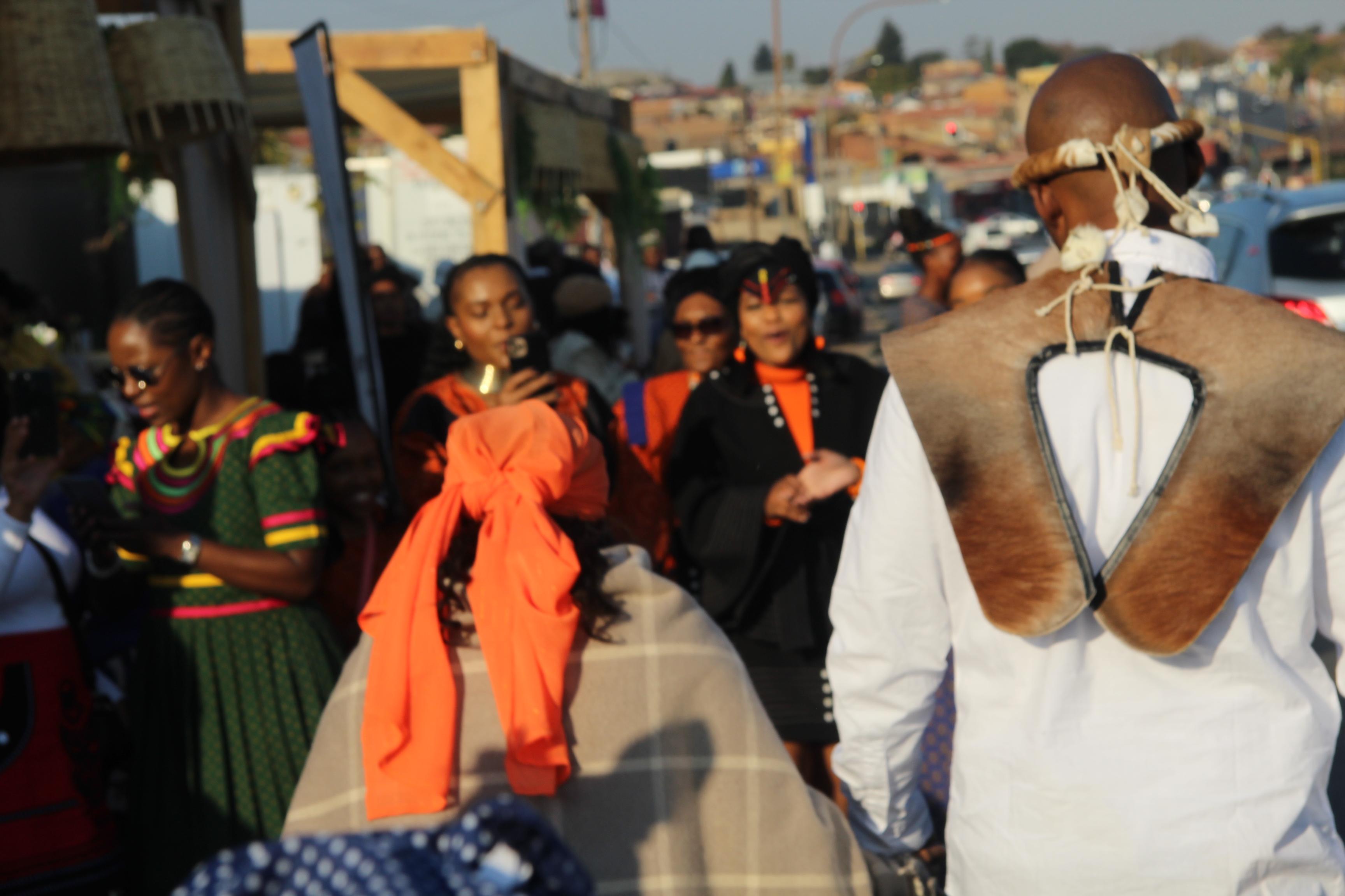 Guests in traditional dress walking together at a ceremony